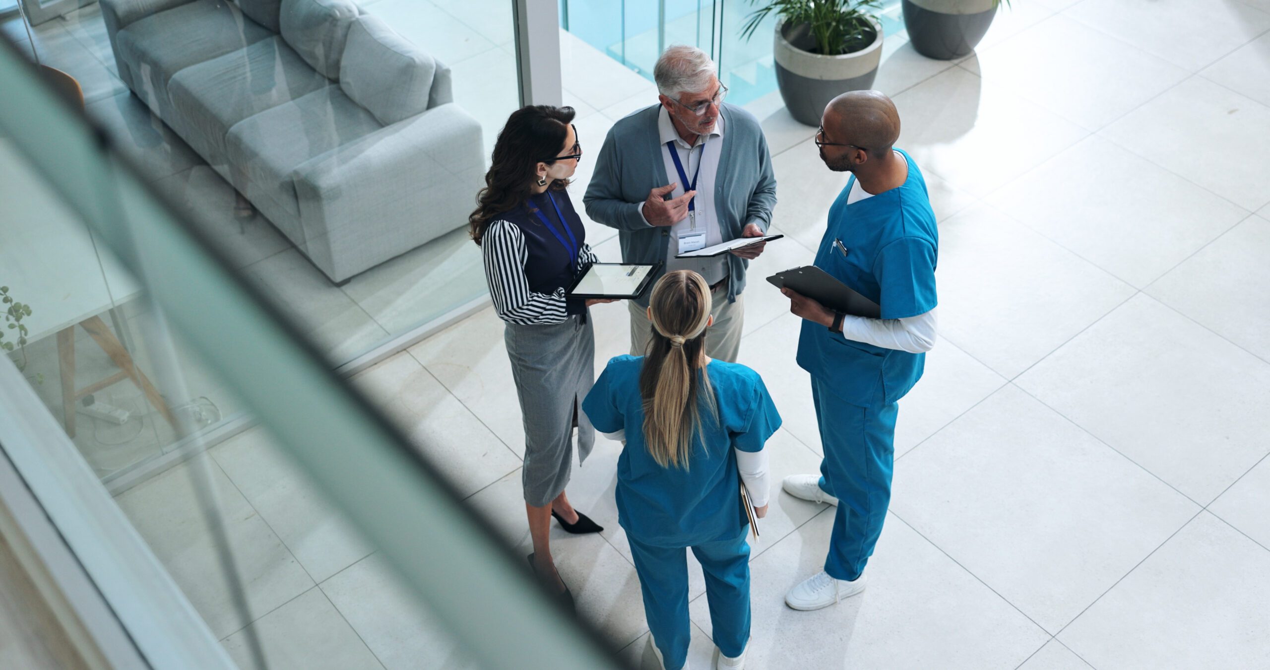 Doctors, medical team and tablet with discussion, advice and above for surgery or patient records. People, tech and nurse for professional opinion, help and results in healthcare, clinic or hospital.