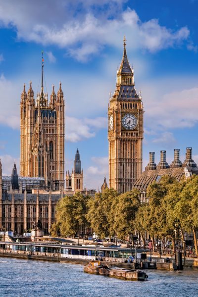Big Ben and Houses of Parliament with boats on the river in London, England, UK